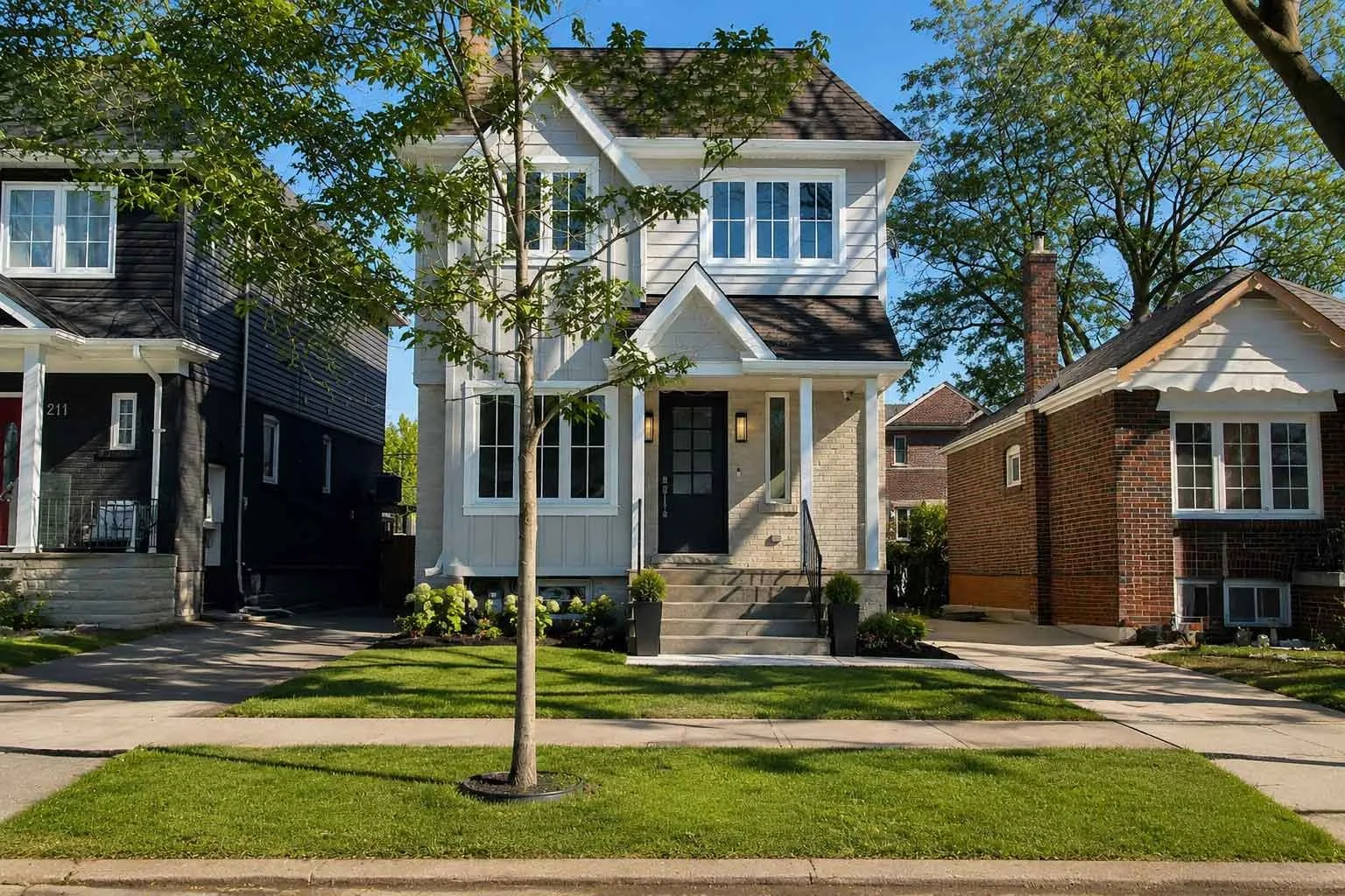 Rear exterior of a Toronto home addition by Waterfront, with new windows and matching exterior finishes