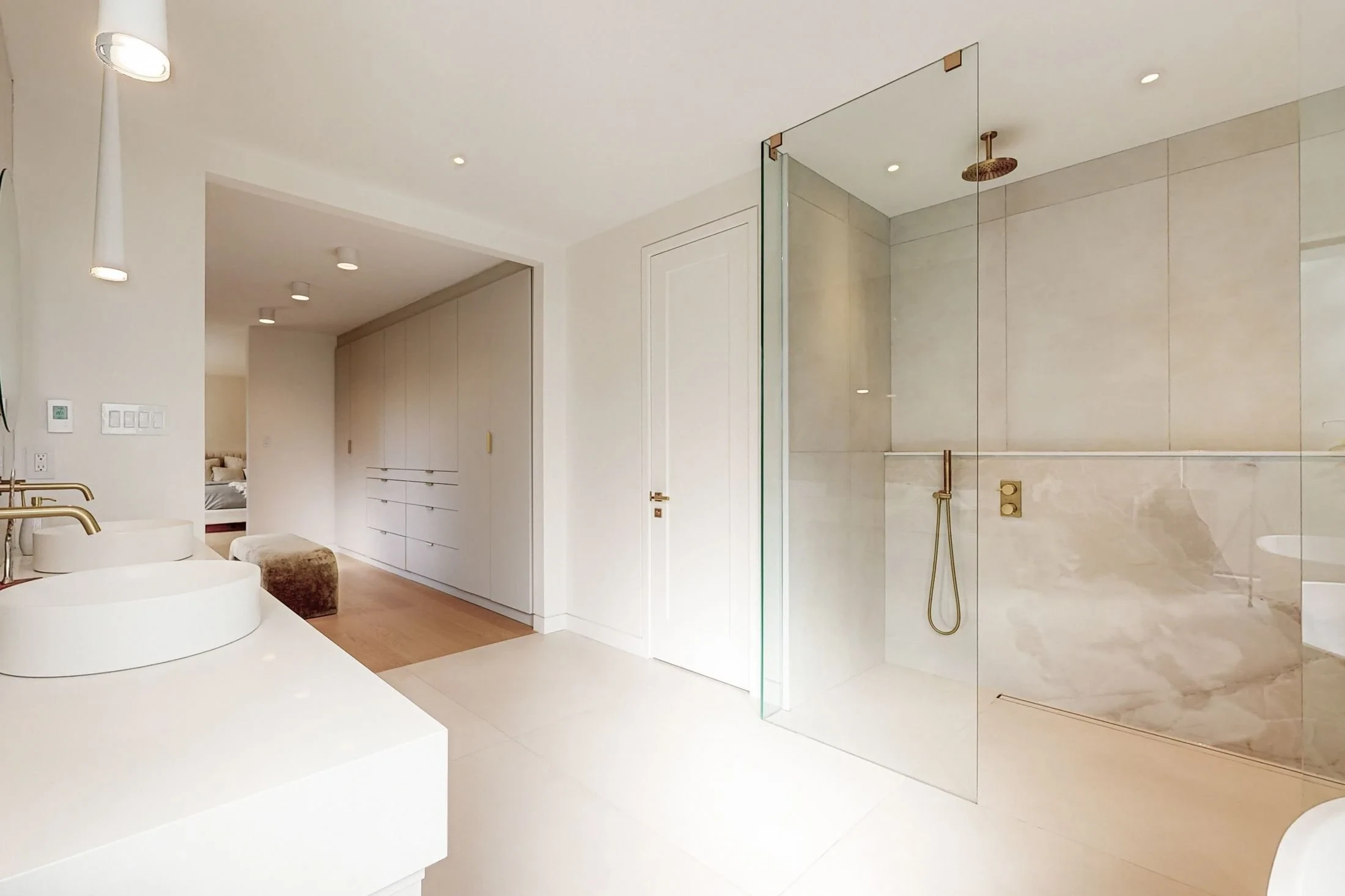 Ensuite with a glass walk-in shower, brass fixtures, and marble-look surfaces.