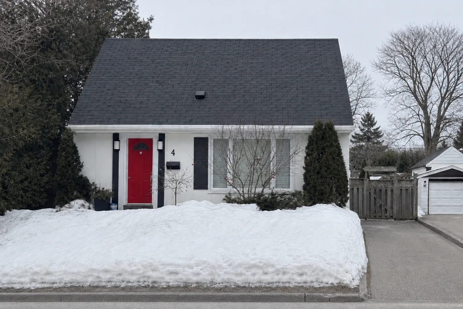 Winter street view of the original one-storey house before the second-storey addition, Modern Sanctuary project.