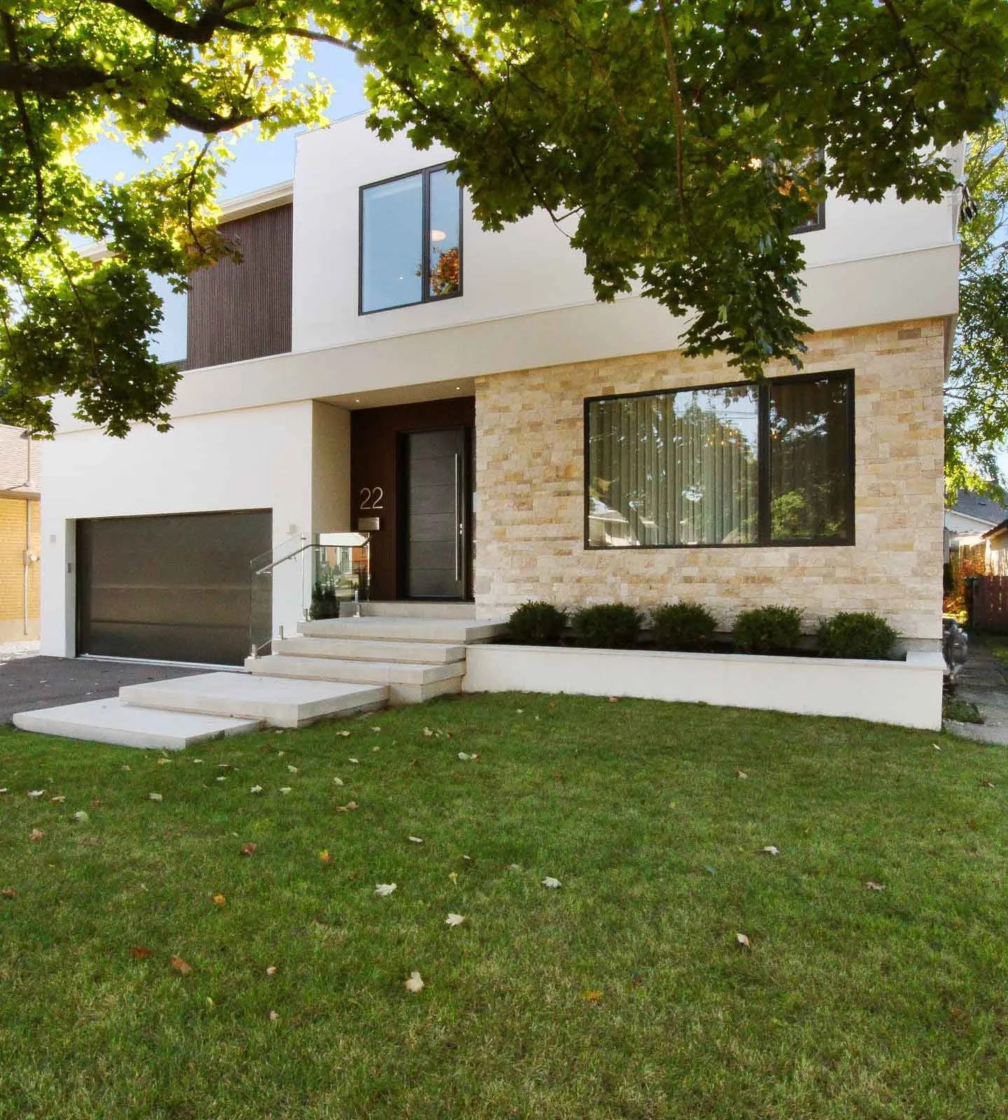 A Spanish style home with a light stone exterior, designed by Waterfront, a design-build firm